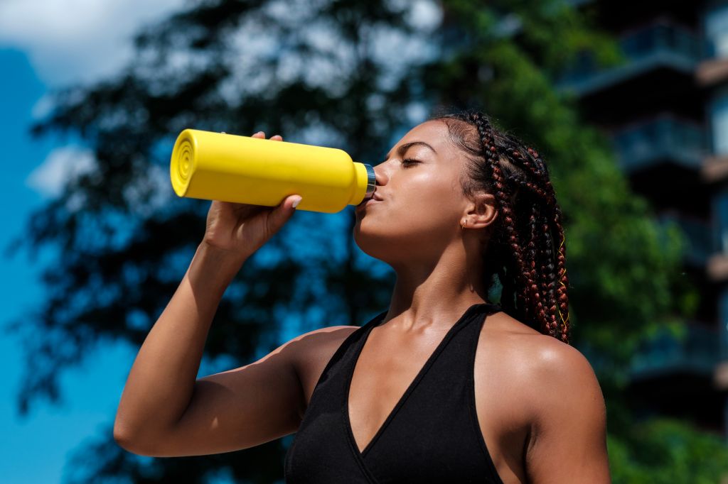 Athletic women drinking from bottle
