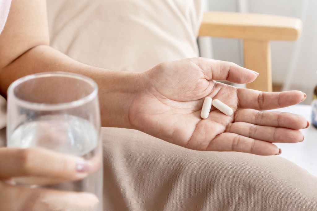 Hand holding capsules 