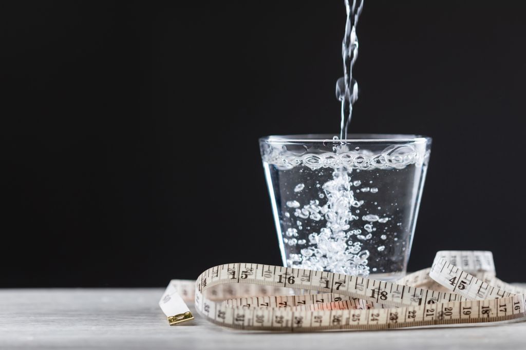 Glass of water wrapped in a measuring tape