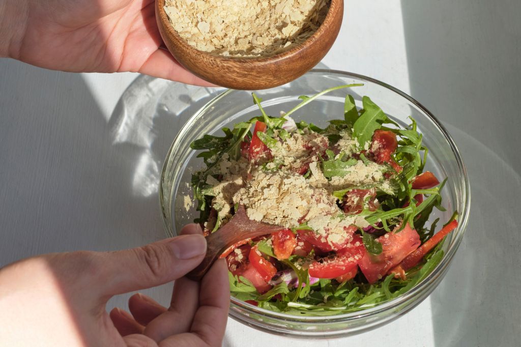 Sprinkling yeast on a salad