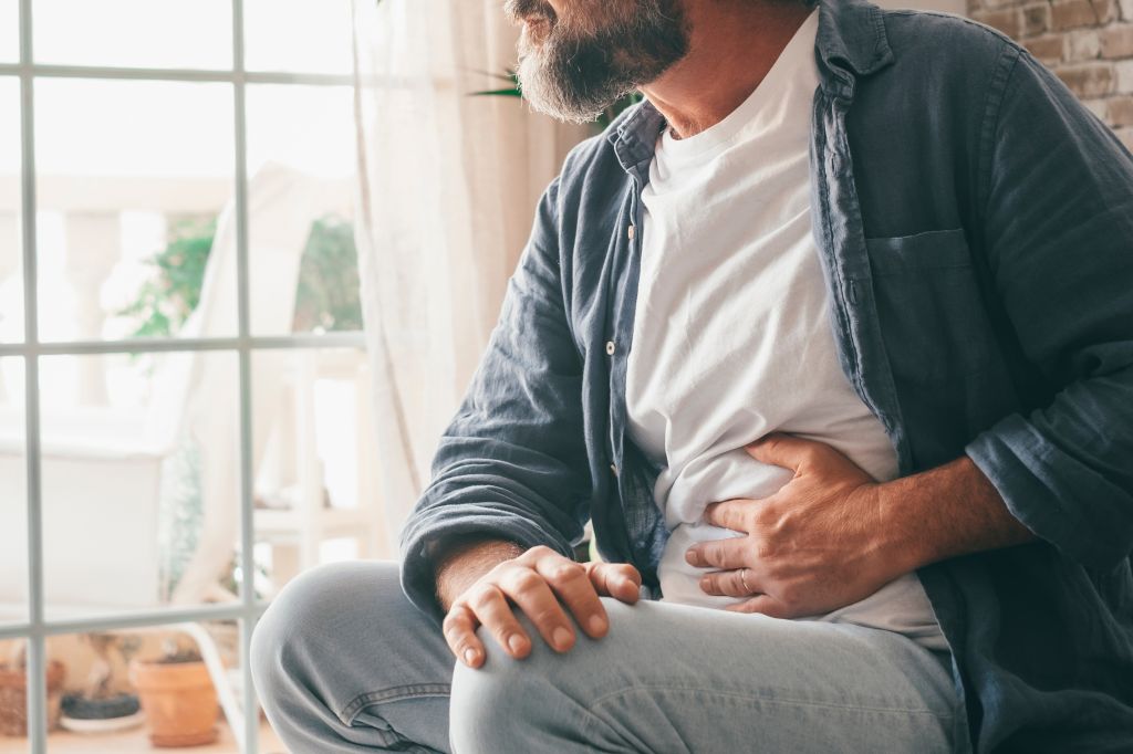 Man holding stomach 