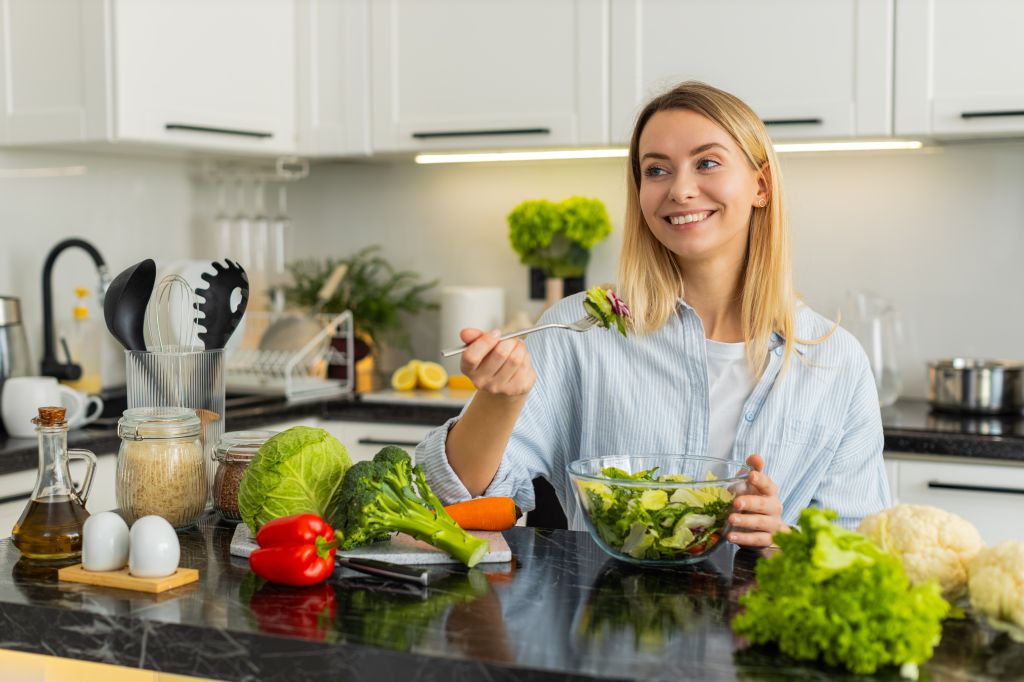 Woman eating leafy greens 