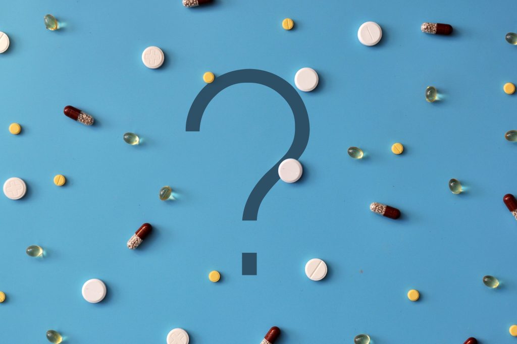 Question mark surrounded by pills