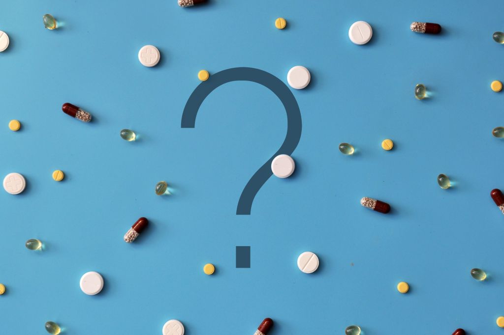 Question mark surrounded by pills