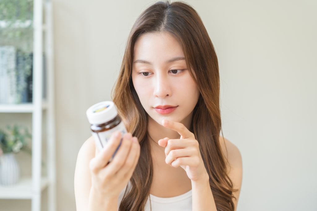Woman looking at a supplement