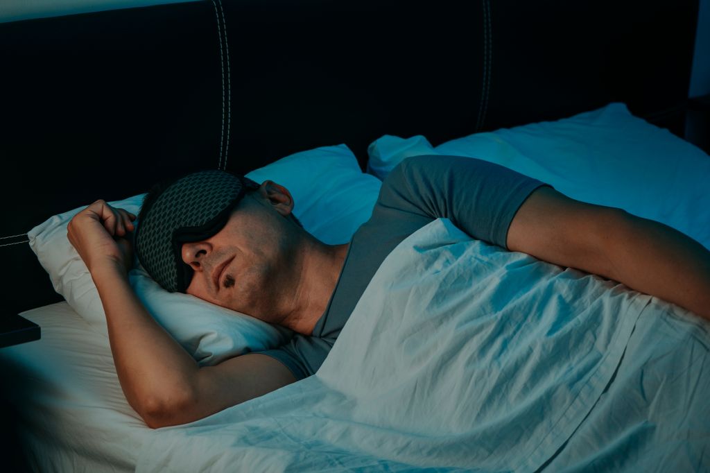 Man sleeping with an eye mask