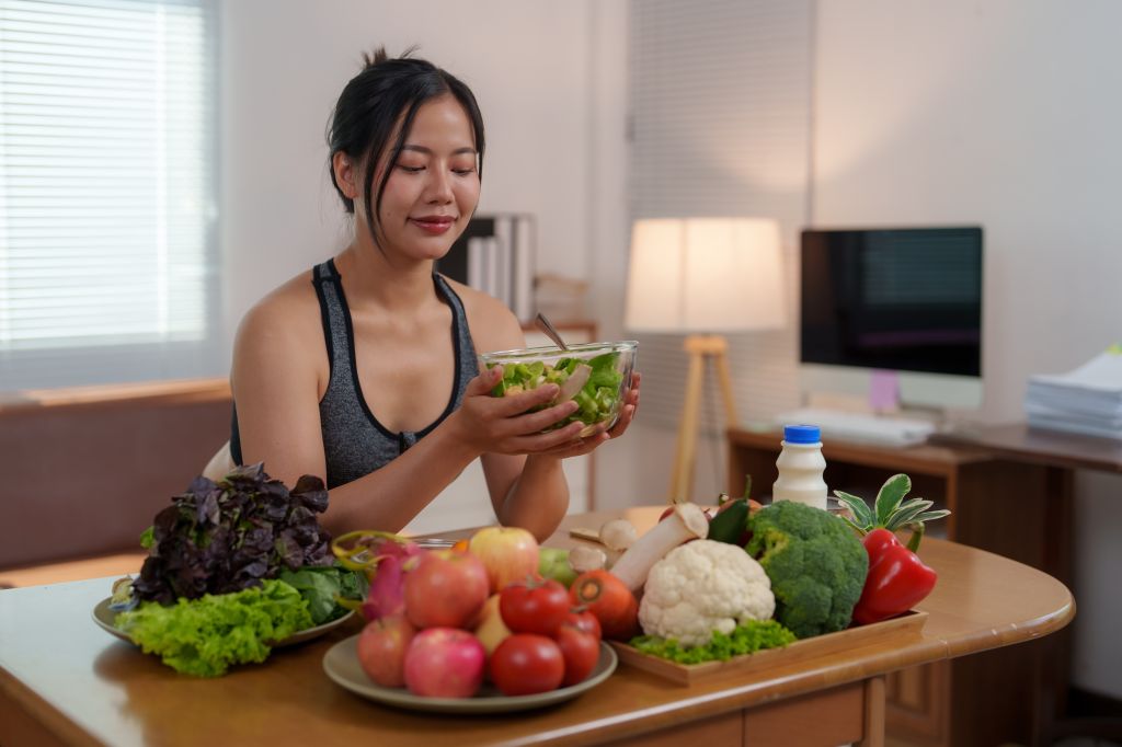 Woman holding a bowl of salad 