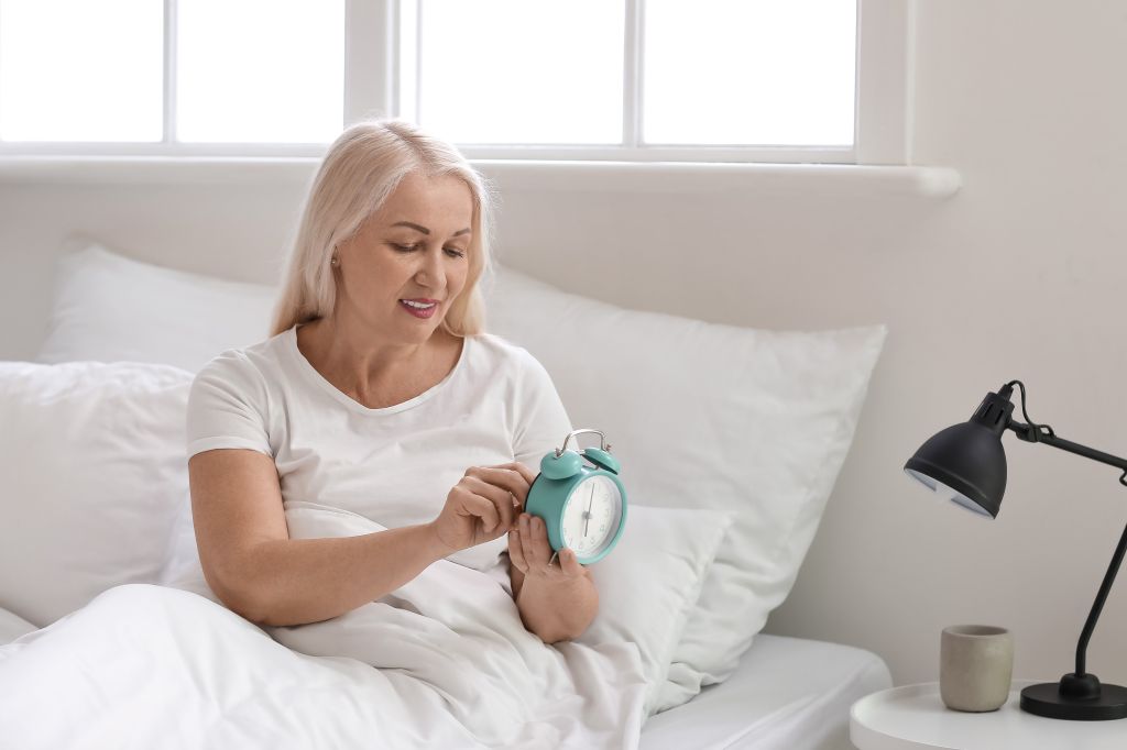 Woman setting an alarm