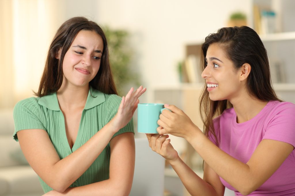 Woman turning down coffee 